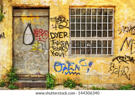 Abandoned shop exterior covered with graffiti in Athens, Greece