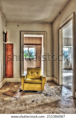 Yellow armchair in an abandoned house, HDR