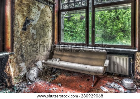 Abandoned hotel interior with couch, HDR