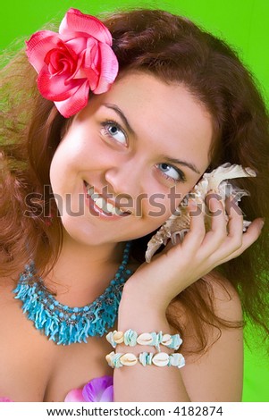 photo of a beautiful girl with flower in her hair with shell