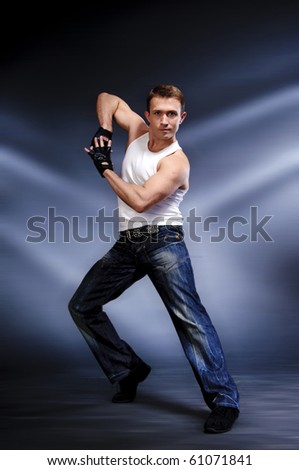Dancing man in jeans and white sports jersey