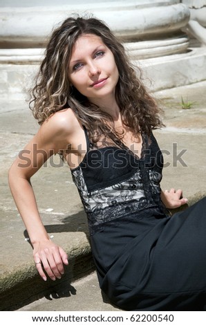 Beautiful woman sitting against column