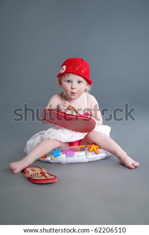 Little girl trying mother shoes