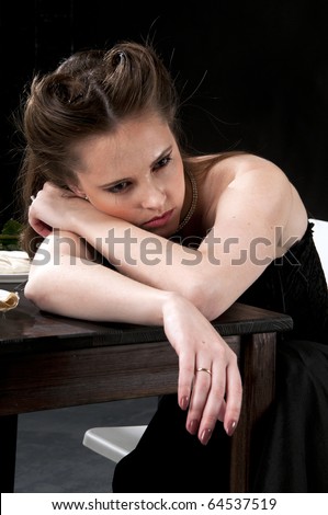 Alone sad crying woman. Studio shot, black background