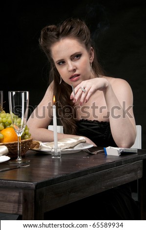 Alone sad woman sits in restaurant, smoking and thinking. Studio shot