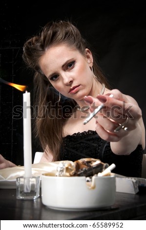 Alone sad woman sits in restaurant, smoking and thinking. Studio shot