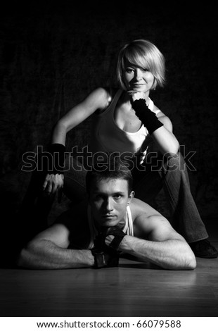 Sport dance couple posing on the floor. Black and white colors