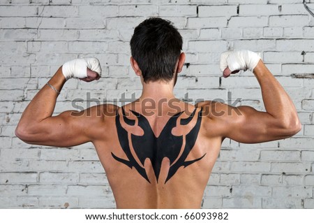 stock photo Male's back with tribal tattoo