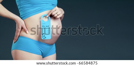 Pregnancy concept: belly close-up with \