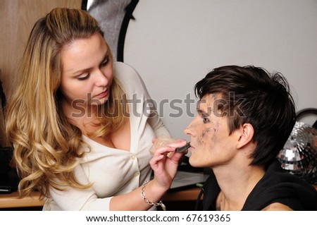 glamour model makeup. stock photo : Backstage scene: visagiste at work doing glamour model makeup.