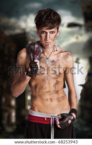 Portrait of rebellious urban man against aggressive street background.