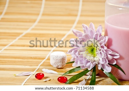 Spa concept - spa accesories with flower on bamboo background