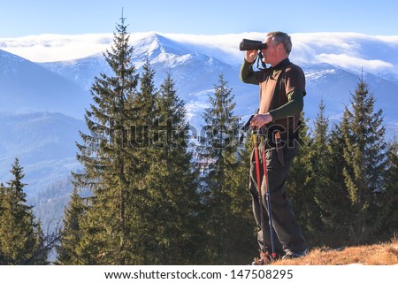 Man who is studying tourist route in the mountains