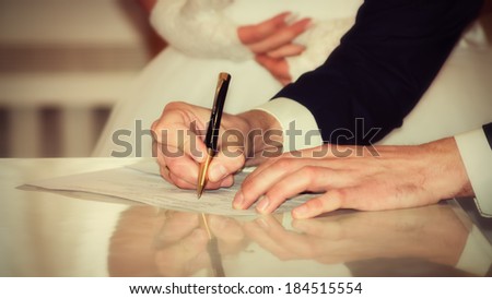 Bride and Groom Signing Marriage Certificate