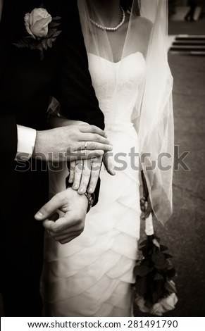 Just married couple holding hands, black and white