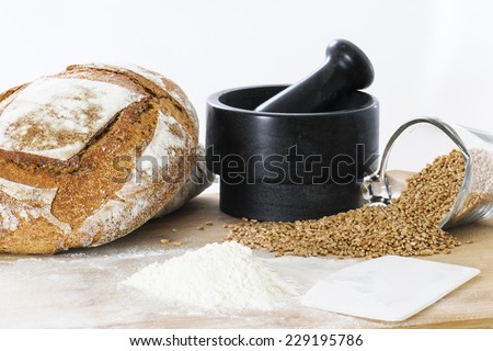 Flour and wheat for breadmaking on a bakers work table