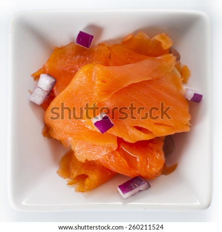 Dish of fine sliced smoked salmon lox and purple onions