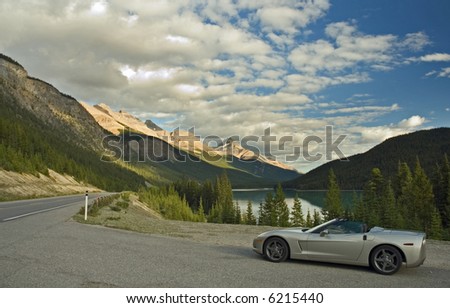 Convertible on the highway at a mountain lake
