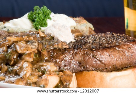 Prime Rib steak on garlic toast, with Blue Cheese and rosemary stuffed potato, mushrooms in balsamic vinegar reduction, with horseradish sauce and beer.