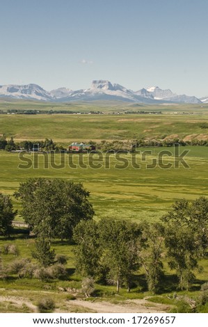 Farmland and buildings in the foothills of the rocky mountains in southern Alberta, Canada