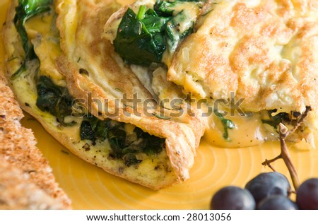 Spinach and cheese omelet with whole wheat toast and grapes