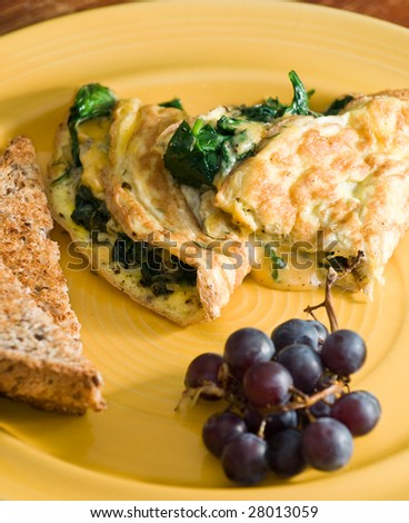 Spinach and cheese omelet with whole wheat toast and grapes