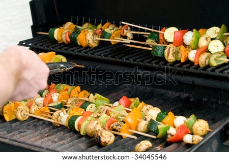 Vegetable skewers being cooked on a grill