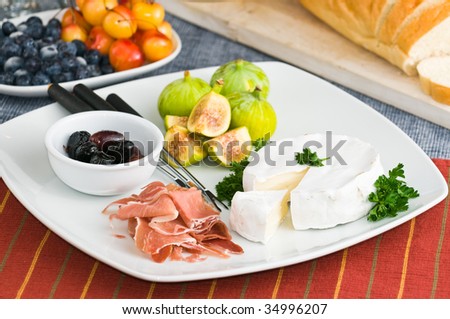 Party table setting with fresh fruits cheese and meat snacks
