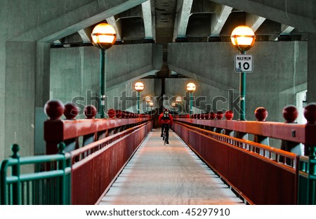 Walking bridge under a traffic bridge across a river