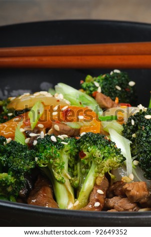 Beef Stir-Fry with broccoli, carrots, onions, peppers, sesame seeds, and ginger on rice