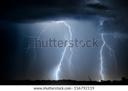 Divine Light.Sky With Lightning Bolt And Silhouette Of A Cityscape