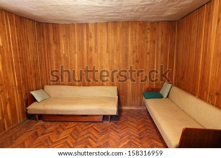 Old sofas/couches in wooden room, wooden wall as well as wooden floor, Adobe RGB profile