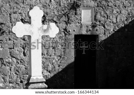 Shade on the faith, Detail of orthodox cross in front of church doors, Black and White