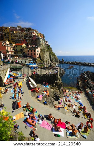 Manarola, Italy-09.August 2014., Tourists are sunbathing at UNESCO World Heritage Site, Cinque Terre, Italian Riviera, Liguria