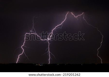 Divine Light, storm is coming, Sky with lightning bolt and silhouette of a cityscape