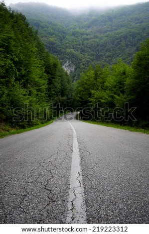 Road to the mountains, Single lane road and mountain in the cloud