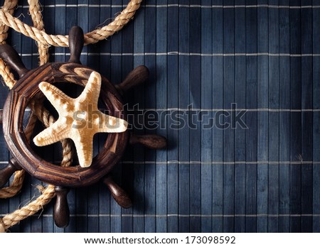 Few nautical items over blue wooden background.