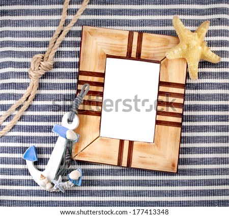 Wooden frame and few marine items in marine still life theme.