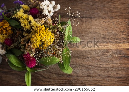Bouquet of dried flowers on a wooden background.