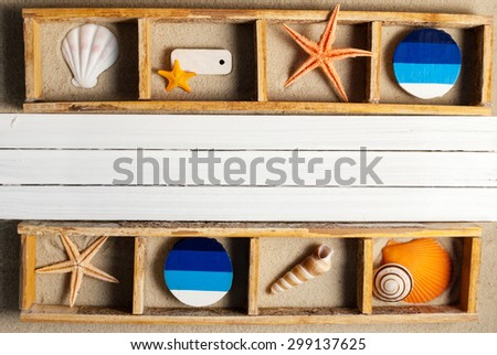 Wooden sections with few marine items on a sandy background.