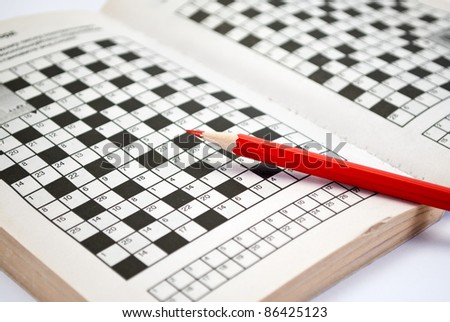 The book of crossword puzzles and red pencil.