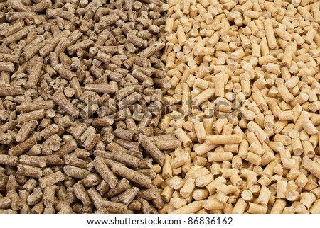 Solid background of dark and light  wooden pellets.