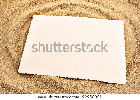 White empty card on a sand. Summer background theme.