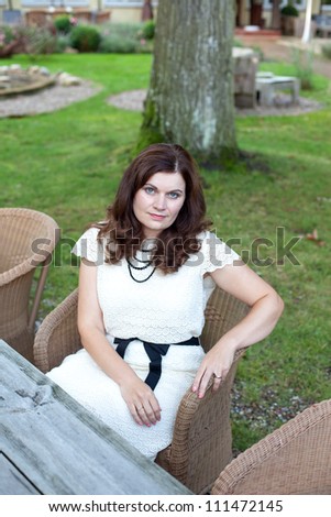 Attractive young woman sitting in outdoor restaurant