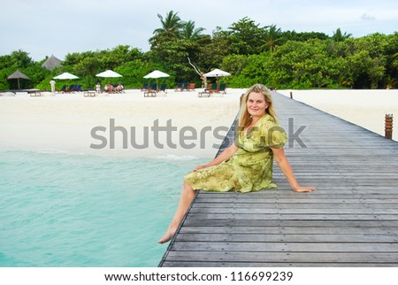 Young woman on wooden landing stage on Maldivian island