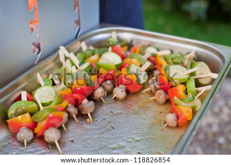 Sizzling barbecue sticks with paprika, onions and mushrooms prepared for grill