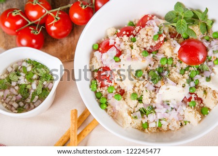 Fresh salad with couscous, pies, tomato, mozzarella, onions and fresh mint