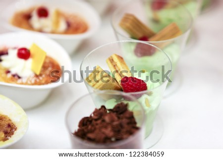 Sweet dessert with raspberry, cookie, chocolate and nut cream