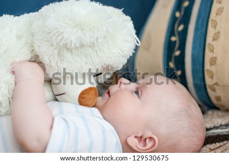 Portrait of little cute baby big bear toy and stripes shirt