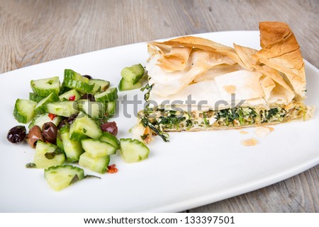 Delicious spinach and feta cheese pie, with crispy filo pastry and Greek cucumber salad